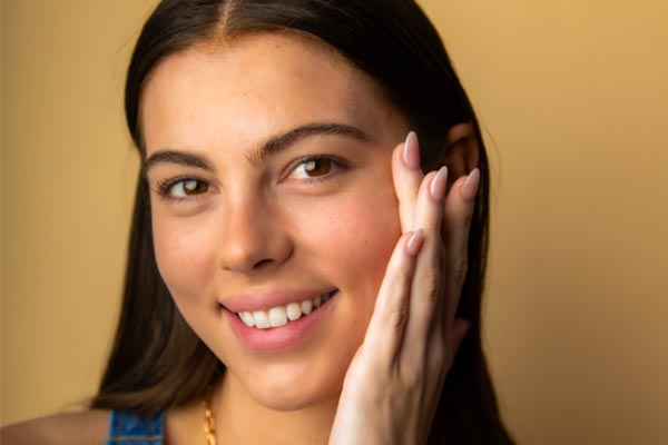 Image of model after using Cotz Face Prime & Protect Tinted SPF 40 to show matte finish