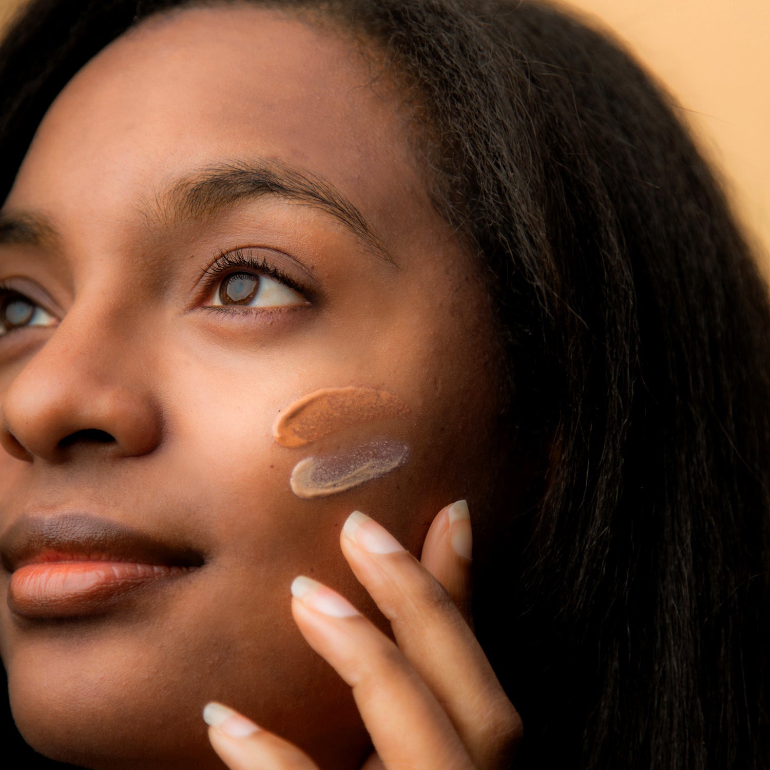 Image of model with both Flawless Complexion Lightly and Richly Tinted swatches on her cheek