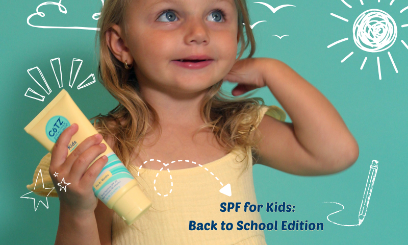 CoTZ kids lotion SPF blog image. Toddler girl holding CoTZ Kids Lotion on a blue background with chalk drawings