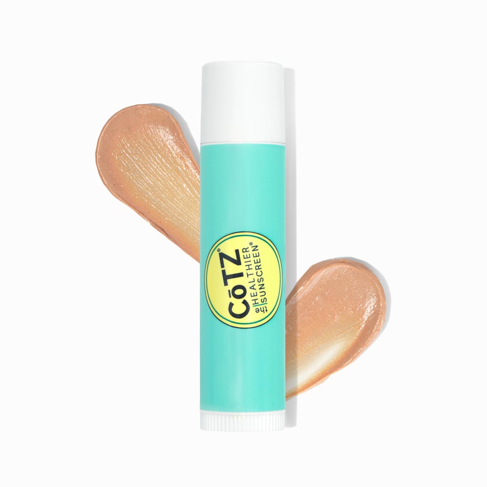 Image of the Cotz Lip Balm Tinted SPF 45 tube with two swatches behind it on a white background