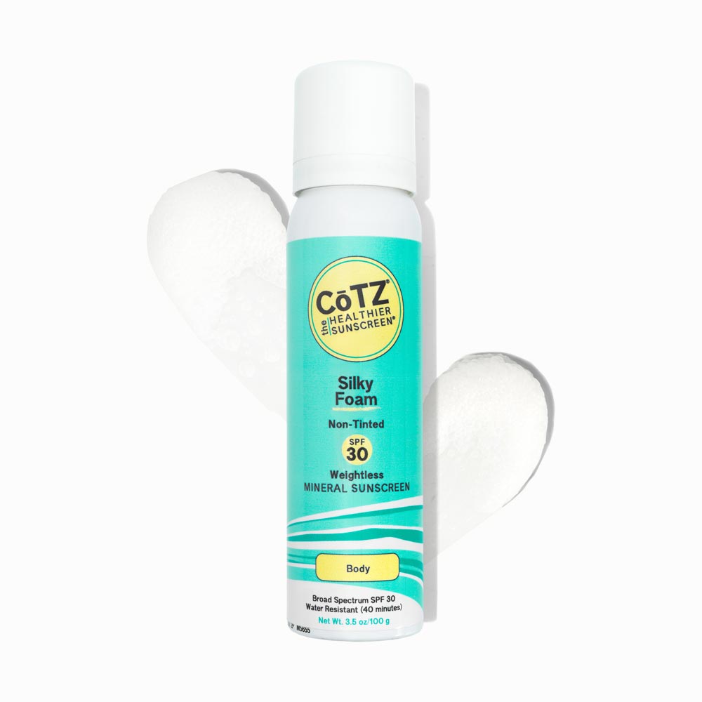 Image of Cotz Silky Foam Non-Tinted SPF 30 tube with two swatches behind it on white background